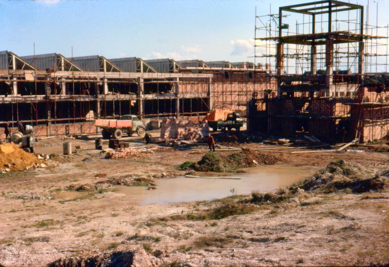 Factory construction in progress showing scaffolding and brickwork