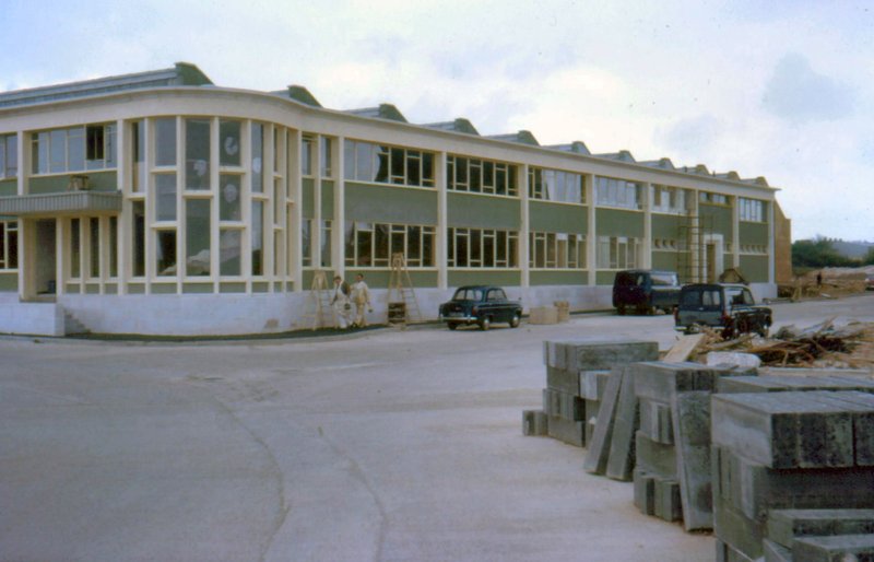 The completed Hilger and Watts factory in colour, showing the green and cream facade